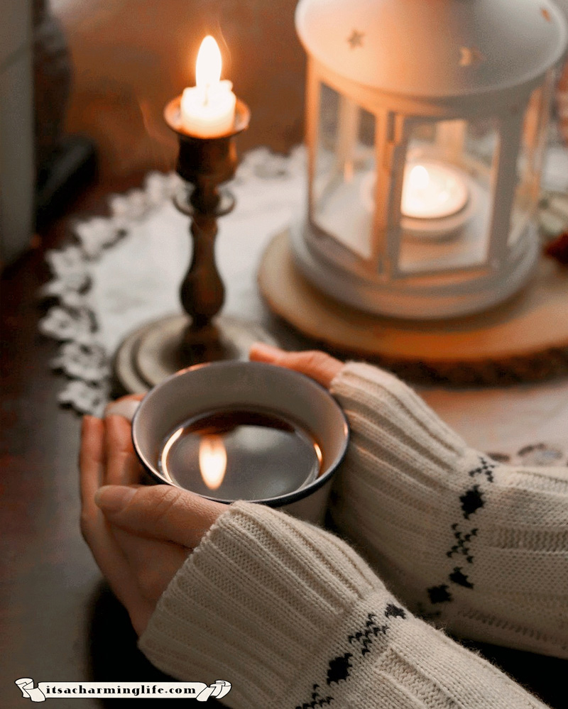 Hygge - Cozy scene - hands holding a cup of tea