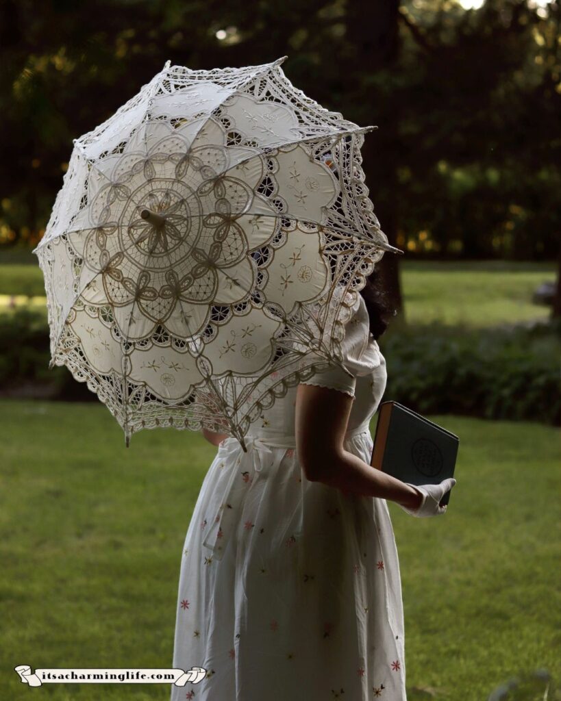 Vintage lady with white parasol holding book